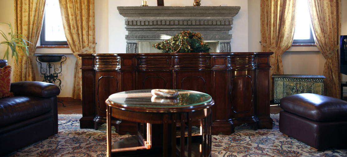 Period detail of the meeting hall: carved credenza and fireplace in the 15th-century residence